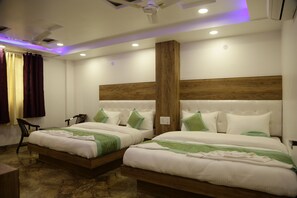 A hotel room with two beds, a wooden headboard, a ceiling fan, and a marble floor. - Hotel True Stay  (New Delhi)