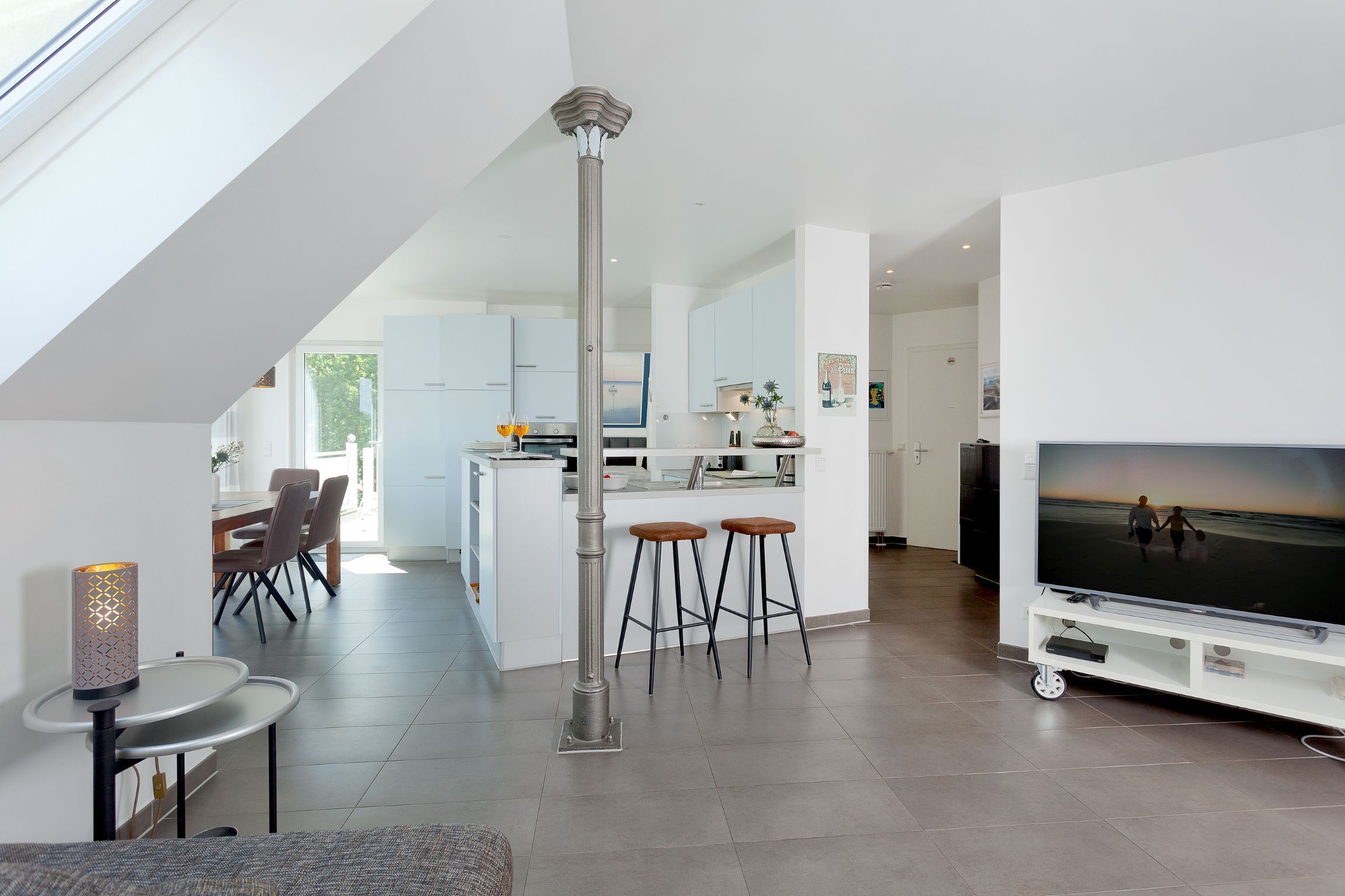 A modern interior with a dining area, kitchen, and living space.