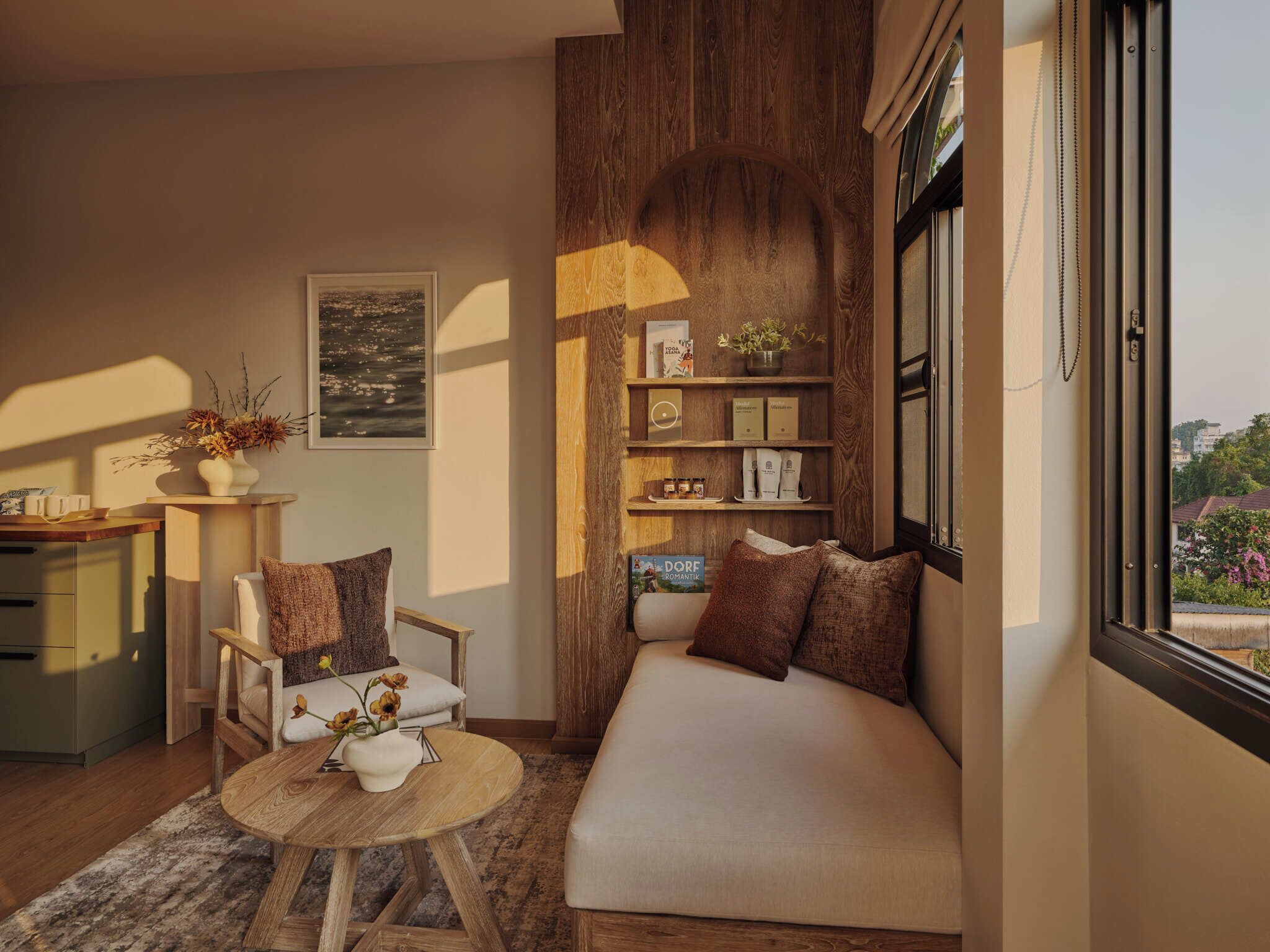 A cozy living room with a wooden accent wall, a sofa, a coffee table, and a bookshelf.