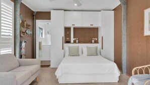 A bedroom with a bed, a sofa, and a wardrobe. - Boudoir on Bryce St - (Pet Friendly to ONE, SMALL non hair shedding dog 4.5kg) (Moffat Beach)