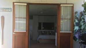 A room with a bed, a window with blinds, and a door. - Boudoir on Bryce St - (Pet Friendly to ONE, SMALL non hair shedding dog 4.5kg) (Moffat Beach)