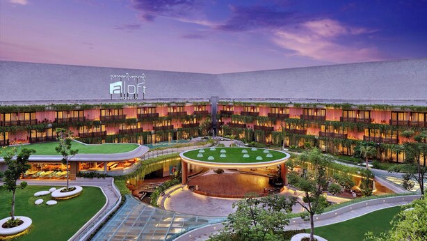A hotel with a central courtyard, multiple floors, and a modern design. - Aloft by Marriott Bali Kuta at Beachwalk (Kuta)