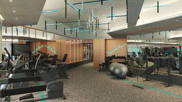 A modern gym with various exercise equipment, including treadmills, stationary bikes, and weight machines.