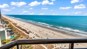 A beach view from a balcony with a clear sky and ocean. - Wow-Fabulous Oceanfront 15th floor 2 Balconies! (Myrtle Beach)
