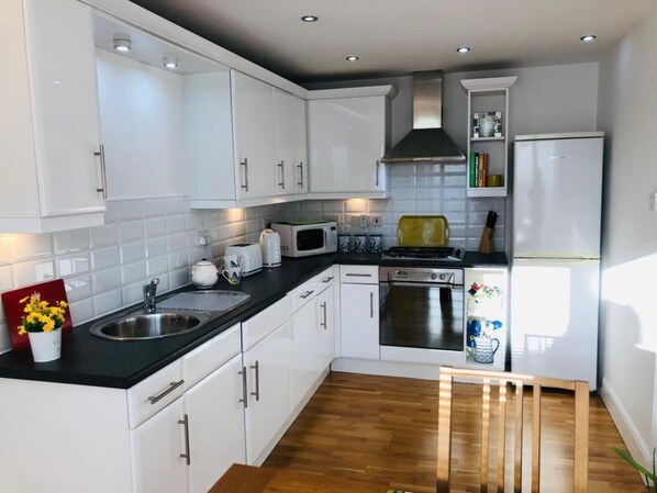 Enjoy cooking in this well-equipped kitchen with a sink, microwave, toaster, and oven.