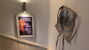 Portaikko, jossa on kehystetty kyltti ja seinällä koriste-esine.