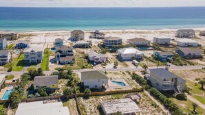 A coastal residential area with houses, a beach, and a swimming pool. - Nicely decorated home with private saltwater pool! Pet friendly! (Pensacola Beach)