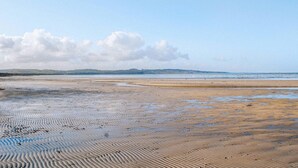 A beach with wet sand and gentle waves. - 2 bedroom gorgeous home in Vig (Vig)