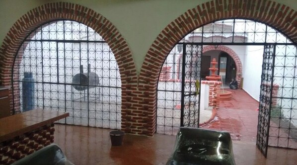 Classic design meets comfort in this traditional room with a dining area, metal gate, and outdoor access.