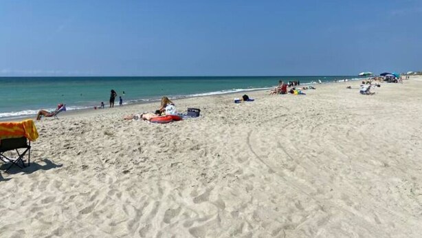 A beach with people sunbathing and relaxing. - Coastal Condo w/ Ocean & Sound Views & Balcony (Emerald Isle)