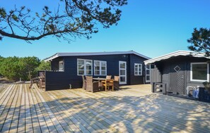 Relax on the spacious deck with a table and chairs, taking in the scenic views through large windows.