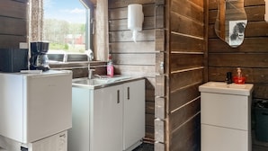 A compact kitchen with a sink, a coffee maker, and a refrigerator. - Beautiful home in Reftele with WiFi (Reftele)