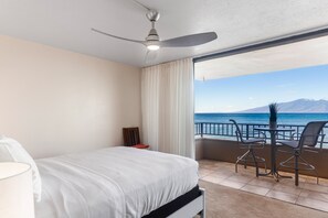 Enjoy breathtaking views of the surrounding mountains from your balcony, featuring a table and chairs.