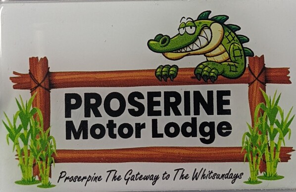A sign for Proserpine Motor Lodge with a cartoon crocodile and text describing it as "The Gateway to The Whitidays." - Proserpine Motor Lodge (Proserpine)
