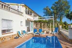 A two-story building with a swimming pool, outdoor seating, and a wooden deck. - Villa Vista | Amazing Sea Views Pool BBQ Air Conditioning Ideal for Families (Tossa de Mar)