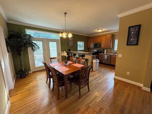 Enjoy meals in the kitchen and dining area with a gas stove, microwave, and wooden table.