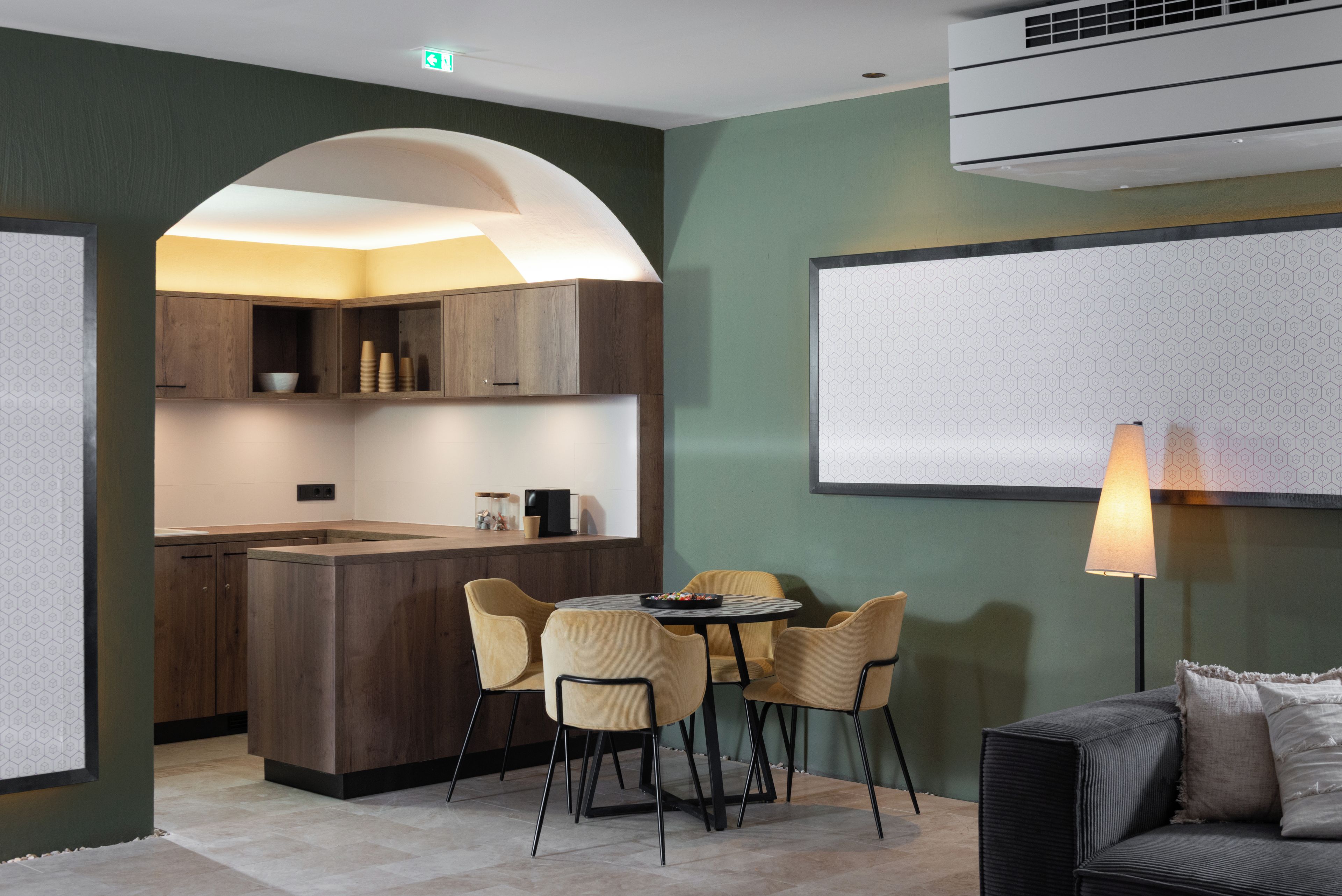 A modern kitchen with a central island, wooden cabinets, and a dining area with chairs and a table.