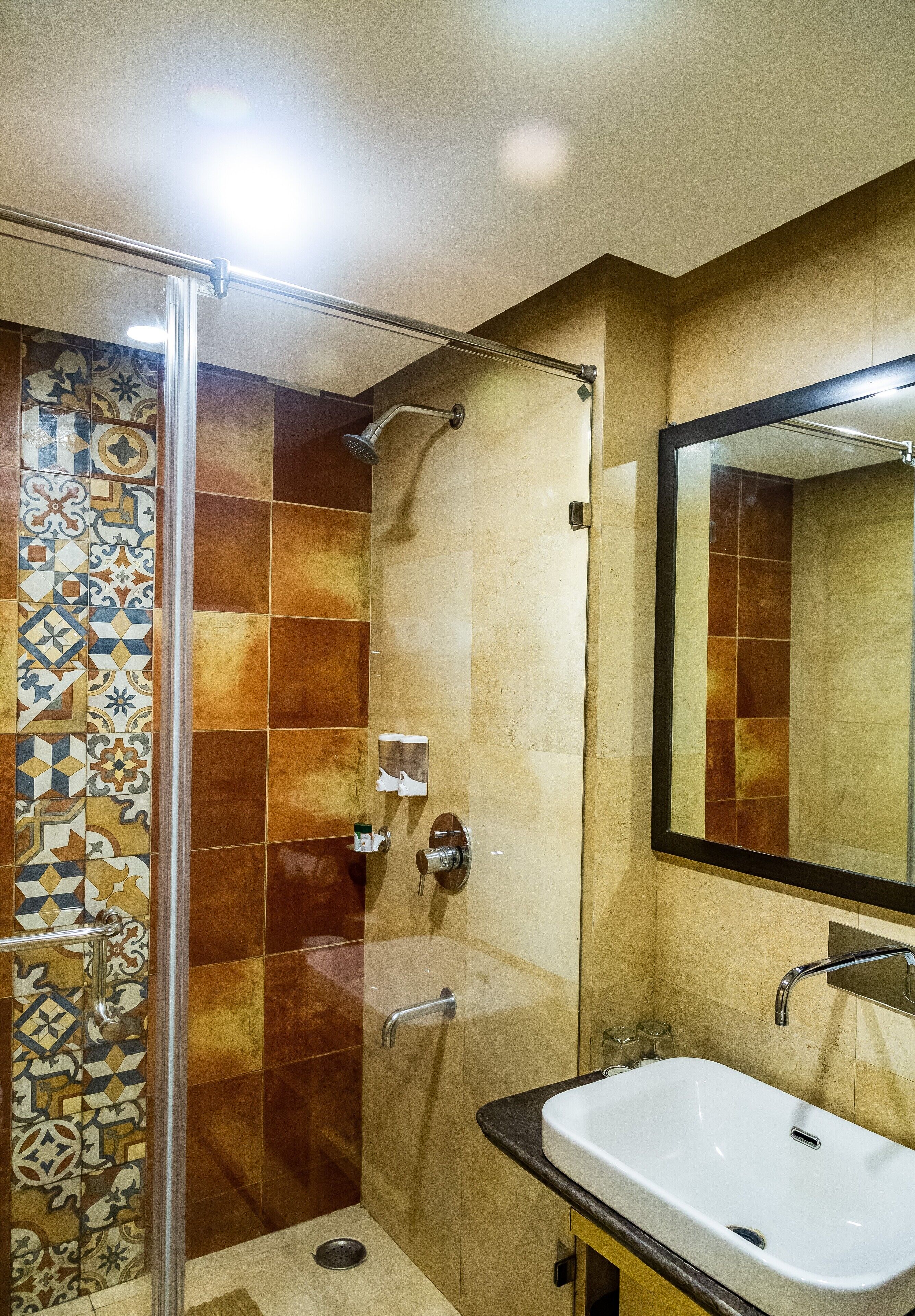 A bathroom with a shower, a sink, and a mirror.