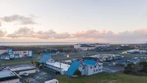 A coastal industrial area with warehouses and a large building with a green roof. - Ocean Song - Queen Studio Room at Wanderlust Inn, Pet Friendly (Ocean shores)