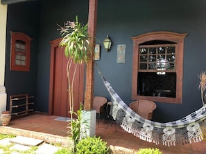 A room with a hammock, a window, and a door.