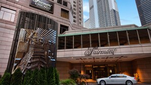 The Fairmont Chicago Millennium Park hotel entrance with a large sculpture in front, surrounded by greenery and a white car parked outside. - Fairmont Chicago at Millennium Park Gold Experience (Chicago)