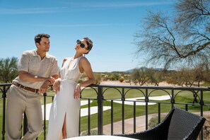 A couple standing on a balcony overlooking a golf course. - Privado Villas at the Fairmont Scottsdale Princess (Scottsdale)