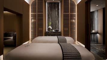 Relax in a stylish space with a large bed, seating area, and decorative touches.