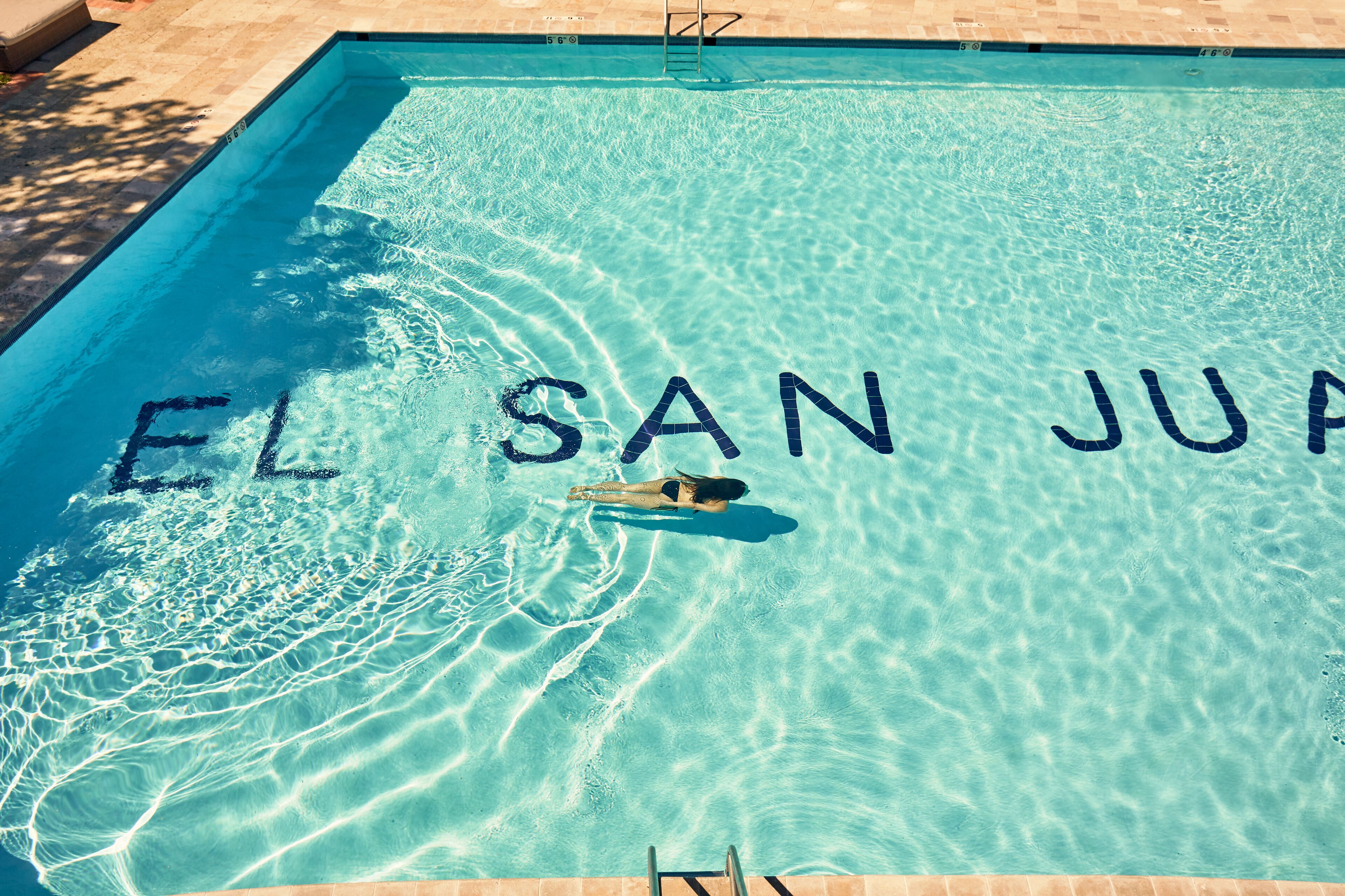 A swimming pool with the words "EL SAN JUAN" written on the water.