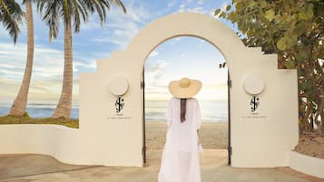 On the beach, white sand, beach cabanas, beach towels