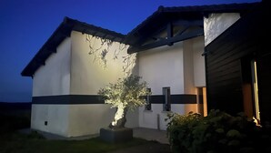 A modern building with a white facade and dark trim.