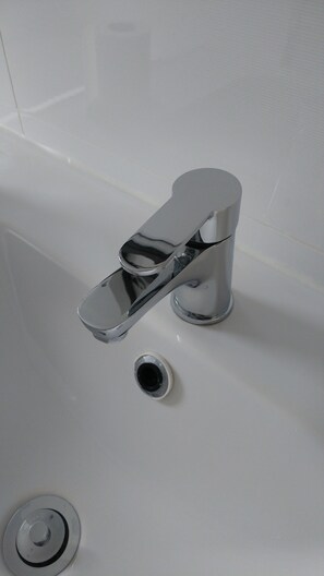 Bathtub, hair dryer, towels, soap