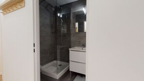 Shower, hair dryer, towels, toilet paper