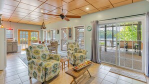 A spacious living area with two patterned armchairs, a wooden coffee table, and a ceiling fan. - Ducktail Pointe - private launch ramp and dock! (Houston)