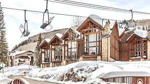A ski resort with wooden buildings, ski lifts, and a snowy landscape. - Ski-in Ski-out, Mountain View, Luxury Townhome, Purgatory Resort (Durango)