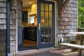 A wooden exterior with a door leading to a kitchen area. - (2027 OPEN!) Lake View Home with Private Pool and Hot Tub! (Harbert)