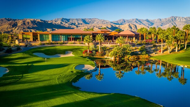 A golf course with a clubhouse, palm trees, and a mountain backdrop. - Completely Remodeled, Full Tennis Privileges, ALWAYS Clean at Palm Valley CC!!   (Palm Desert)