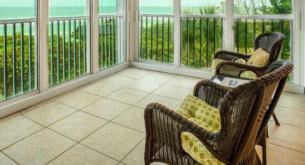 Relax in a tranquil outdoor space with a view of lush greenery and a body of water.