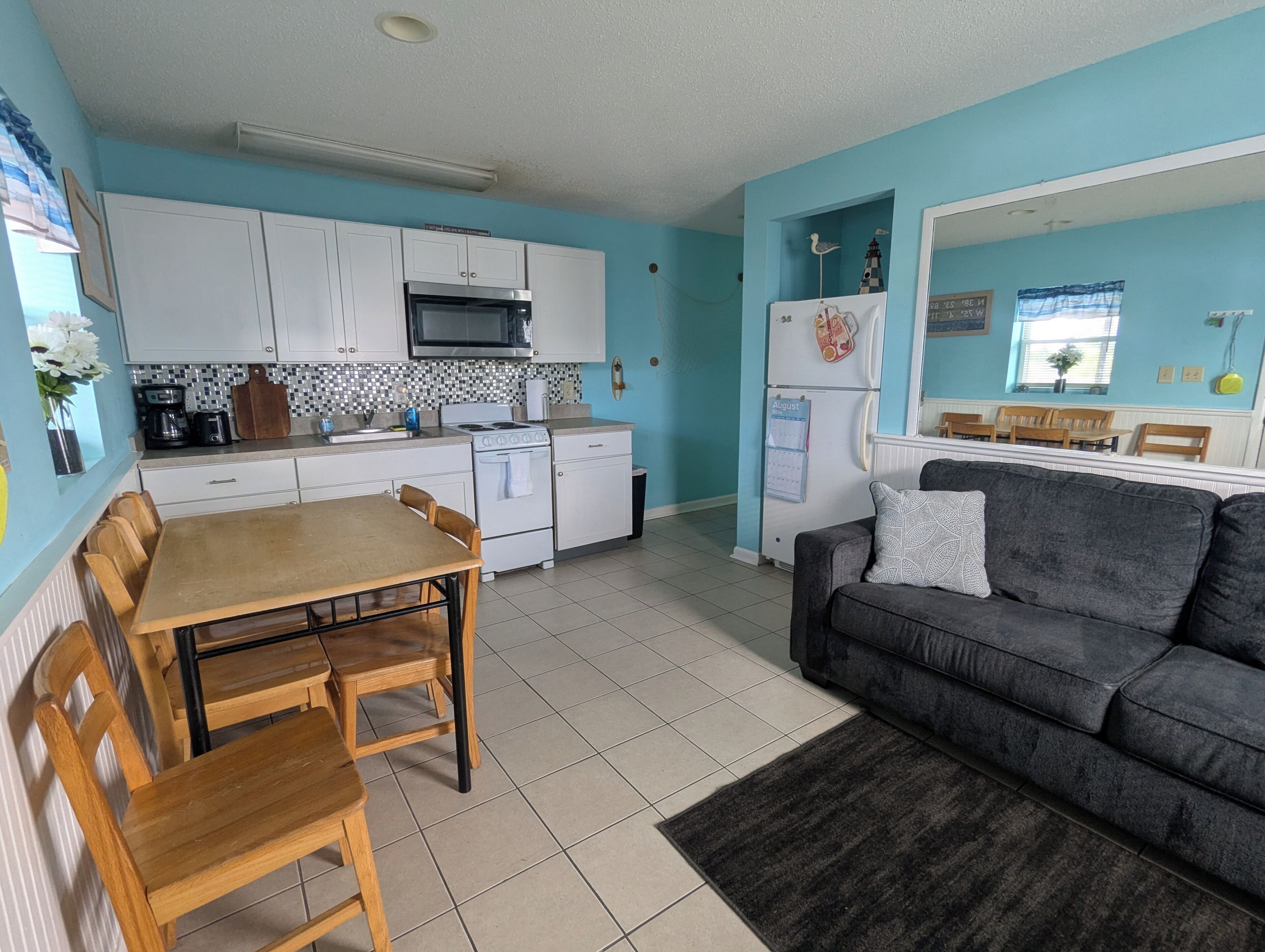 A compact living space with a kitchenette, dining area, and seating area.