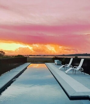 Relax by the rectangular pool with a clear view of the surrounding landscape.