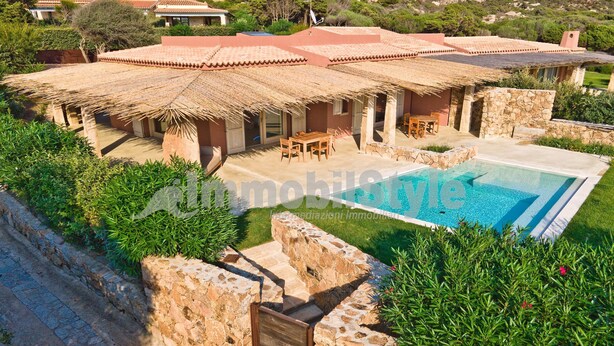 A villa with a swimming pool, outdoor seating, and stone walls. - Exclusive villa with private pool (Santa Reparata)