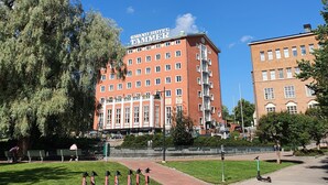 A large red building with a sign reading "GRAND HOTEL" and multiple windows. - Renovated Loft in a Historical Downtown Building (Tampere)