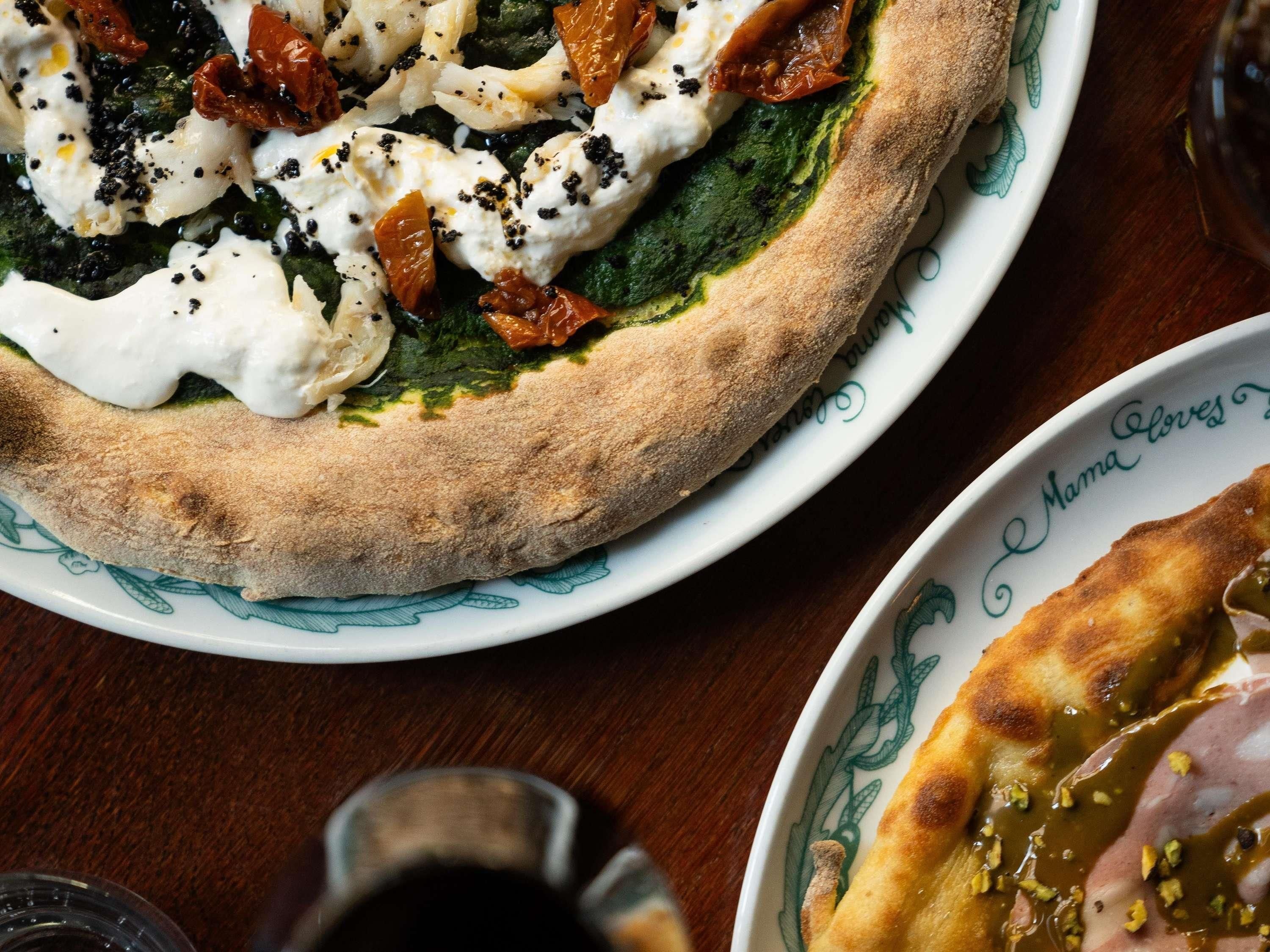 A pizza with toppings on a plate.