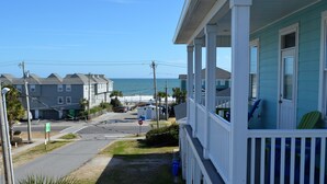 A coastal house with a porch overlooking the ocean. - Moana & Ohana - Walk to beach in Surfside Beach, SC (Surfside Beach)