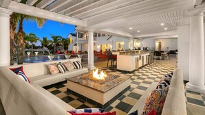 A spacious outdoor area with a pool, a fire pit, and a bar area. - * NEW Luxury Celebrity Vineyard Estate Temecula * (Murrieta)