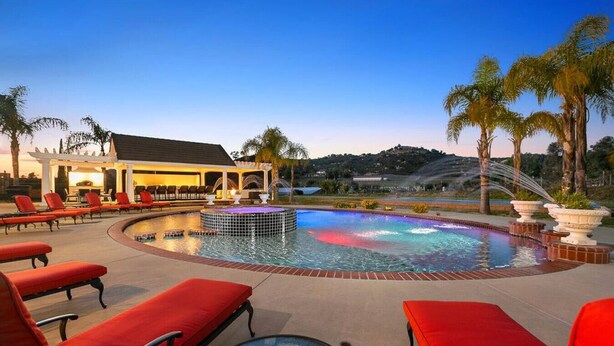 A pool area with red lounge chairs, a hot tub, and a pergola. - * NEW Luxury Celebrity Vineyard Estate Temecula * (Murrieta)