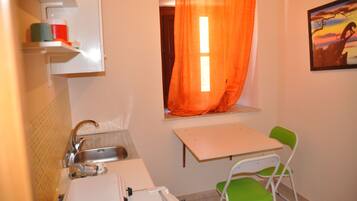 Fridge, cookware/dishes/utensils, spices, lobster pot