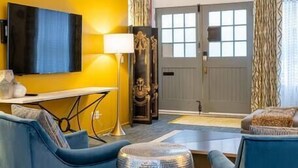 A modern living room with a ceiling fan, a flat-screen TV, and a sofa set. - 35 Carolina Lane  Loft Downtown on Historic Alley + One Free Off Street Parking (Asheville)
