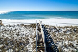 A wooden boardwalk leading to a beach with white sand and a clear blue ocean. - Sugar Sand & Sea - Pool, Spa, Private Beach Access (Destin)