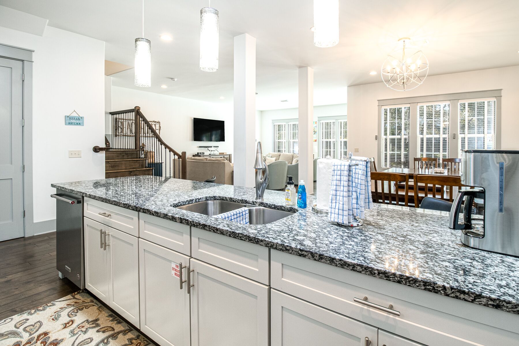 A modern kitchen with granite countertops, stainless steel appliances, and a built-in dishwasher.