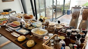 A buffet table with various food items and condiments. - Praia de Santos, Exclusive Villa, Sea-sided with swimming pool, Azores Islands (São Roque)